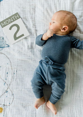 Newborn laying on planetary photo blanket
