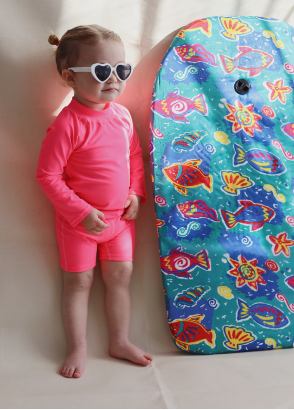 Toddler wearing neon by Nestling swimwear and roshambo hearts sunglasses