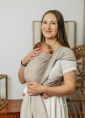 Mum wearing newborn in a patterned woven wrap