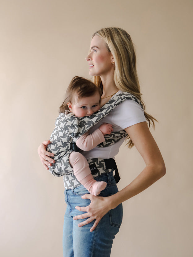 Woman carrying baby on front in boba auri baby carrier
