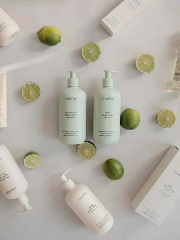 Selection of bodywashes on a table with limes