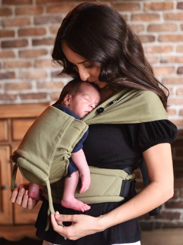 Man wearing preemie baby on chest in a neko tiny baby carrier
