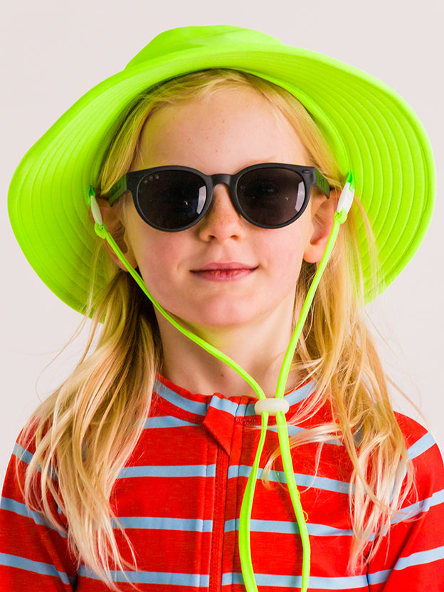 Girl wearing black sunglasses and neon green swim bucket hat