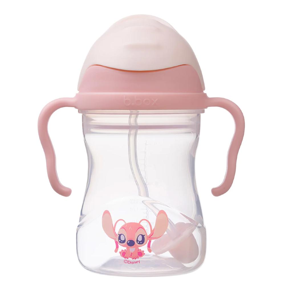 Clear sippy cup with pink lid and handles featuring a cartoon character on a white background