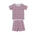 A two-piece baby pajama set featuring a short-sleeve t-shirt and matching shorts in a dense pink, purple, and white floral print on a light grayish-purple background.
