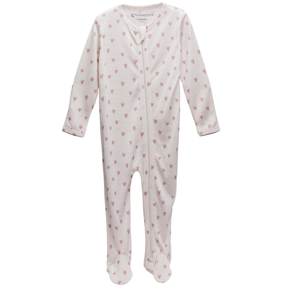 Cream with pink hearts footed merino zipsuit on a white background