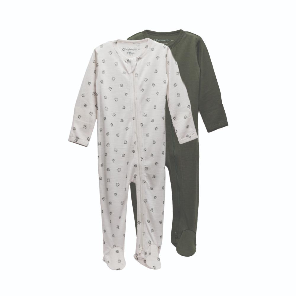 2 footed merino zipsuits, one green, one cream with leaves on a white background