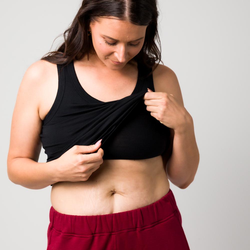 A woman wearing a black singlet and burgundy sweatpants
