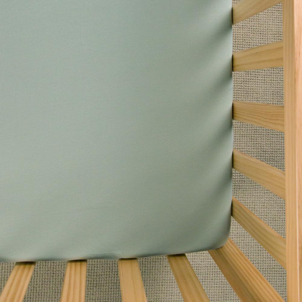 Green fitted sheet on white background