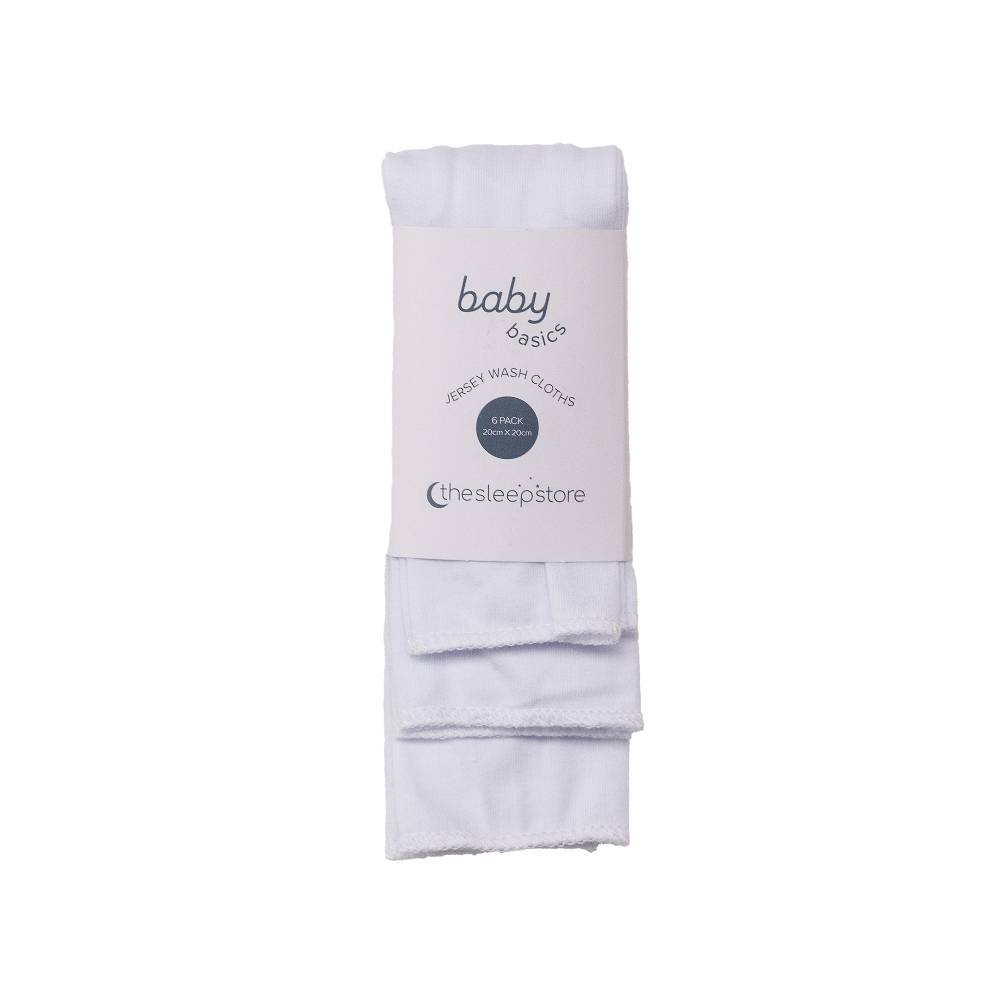Folded white baby washcloth with packaging labeled 'baby basics' on a white background