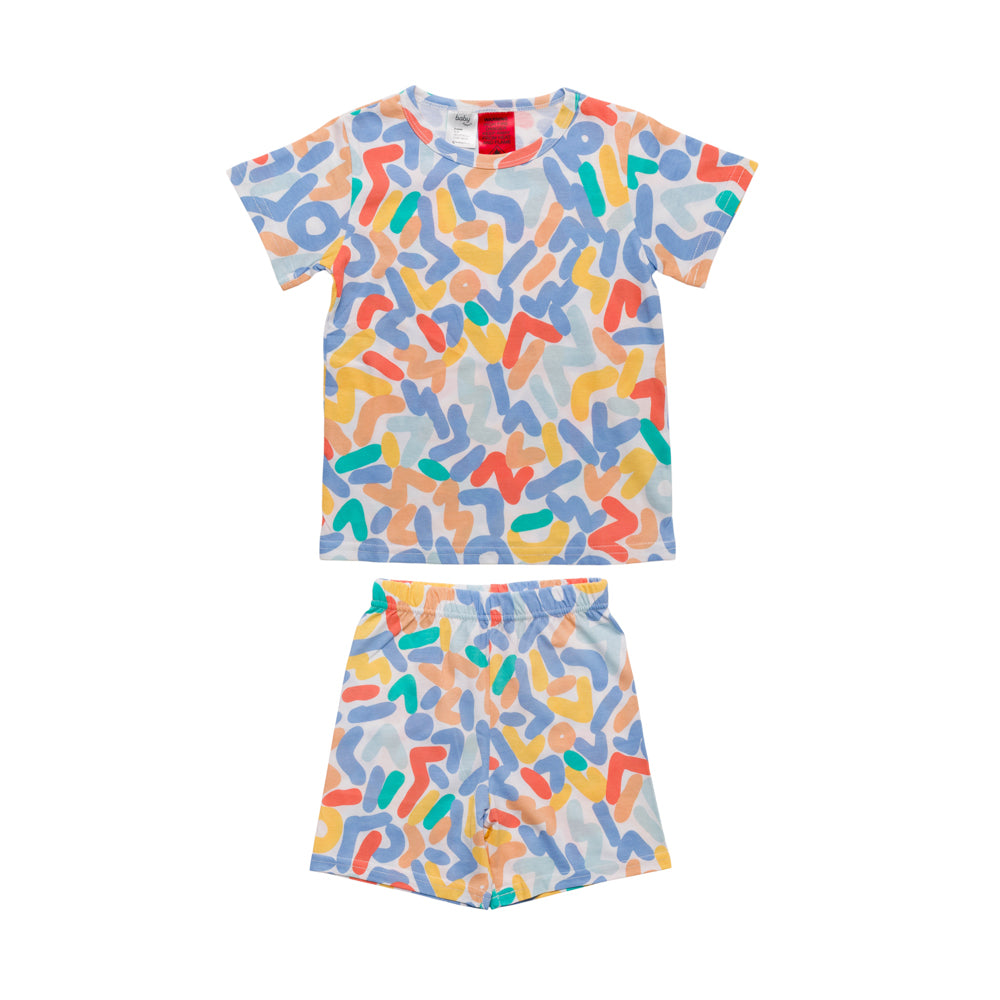 A two-piece kids' pyjama set featuring a short-sleeve t-shirt and matching shorts with an all-over abstract multicolor graffiti-style pattern on a white background.