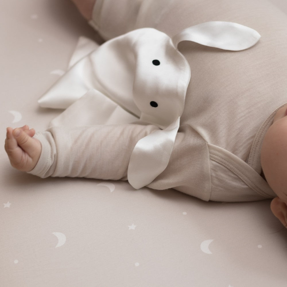 Baby sleeping with silk bunny comforter