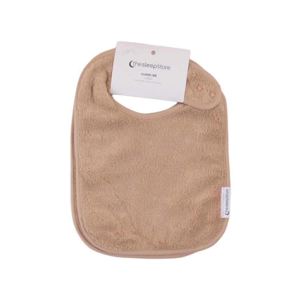 Oat coloured terry cotton classic style baby bib on a white background