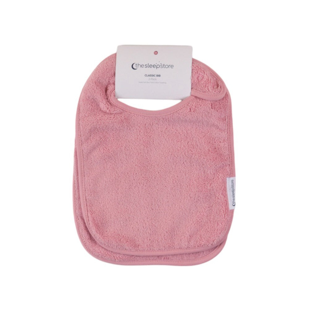 Pink cotton terry classic style baby bib with a label on a white background
