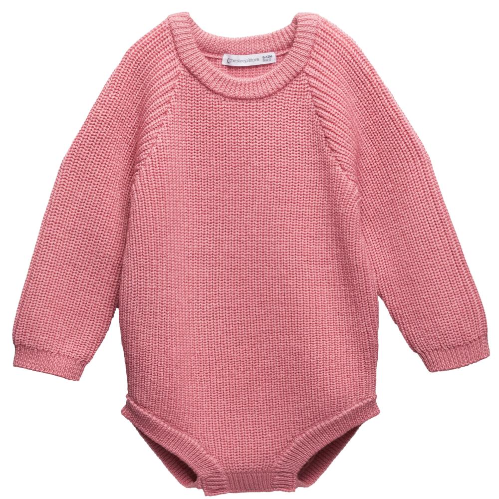 Pink knitted merino wool baby romper with longsleeves on a white background