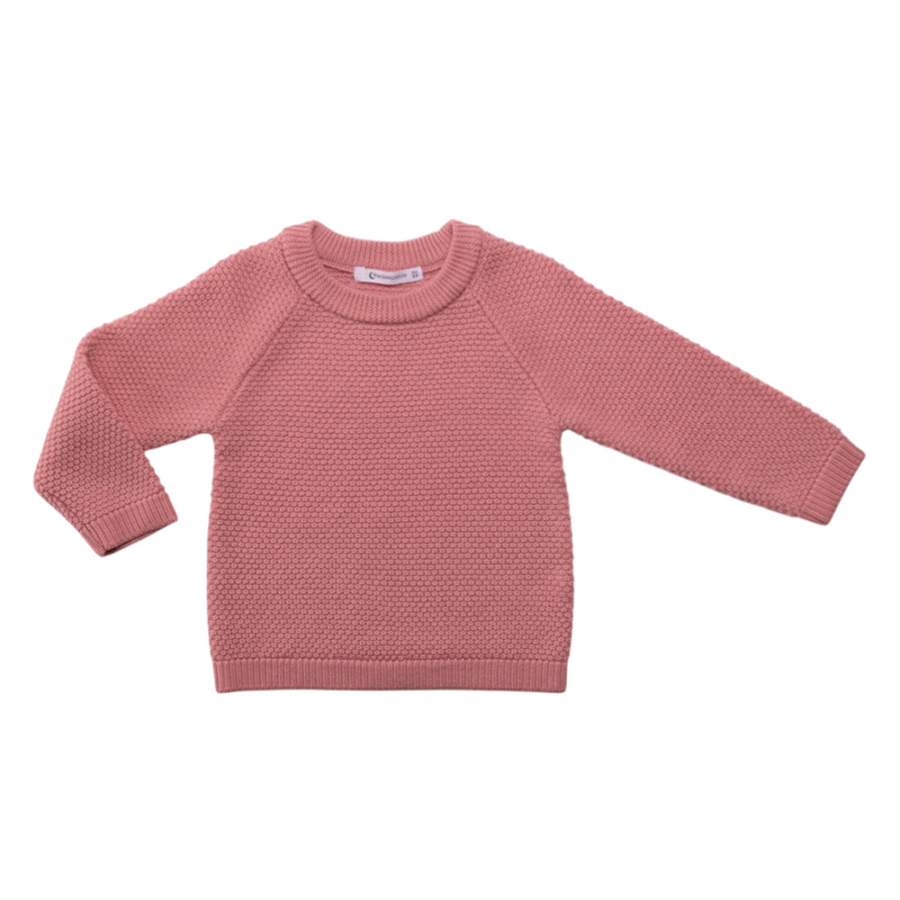 Pink seed stitch woolen knitted sweater on a white background
