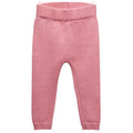 Pink merino wool knitted baby pants on a white background
