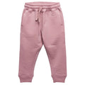 A pair of dusty pink children's merino fleece sweatpants with an elastic waistband, drawstring, and ribbed ankle cuffs, shown against a plain white background.