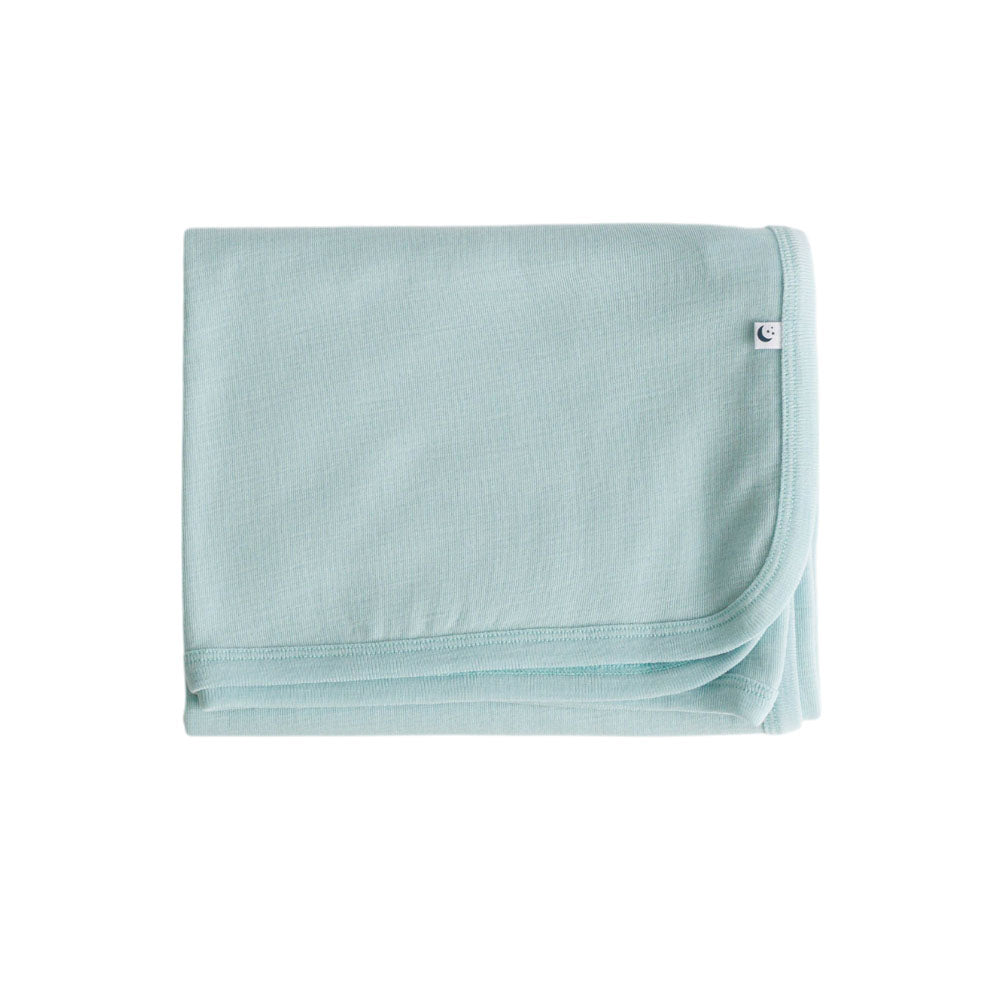 Light blue deluxe merino rib blanket with small logo on a white background