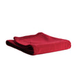A folded red merino/tencel fleece blanket throw with ribbed edges, shown on a plain white background.