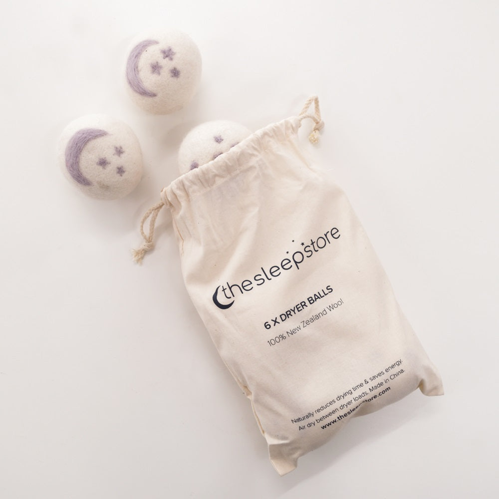 Dryer balls with a branded drawstring bag on a light background
