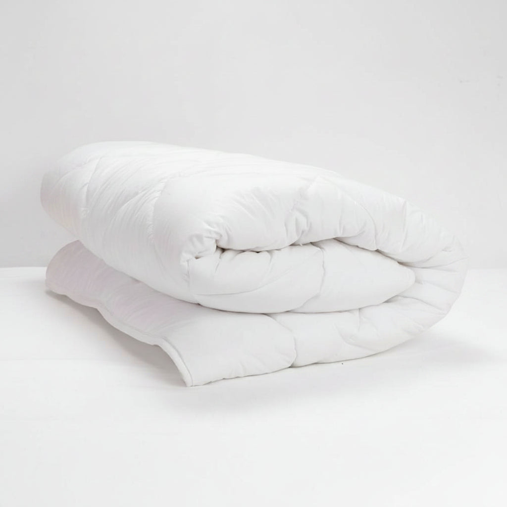 White Duvet Inner rolled up on a white background
