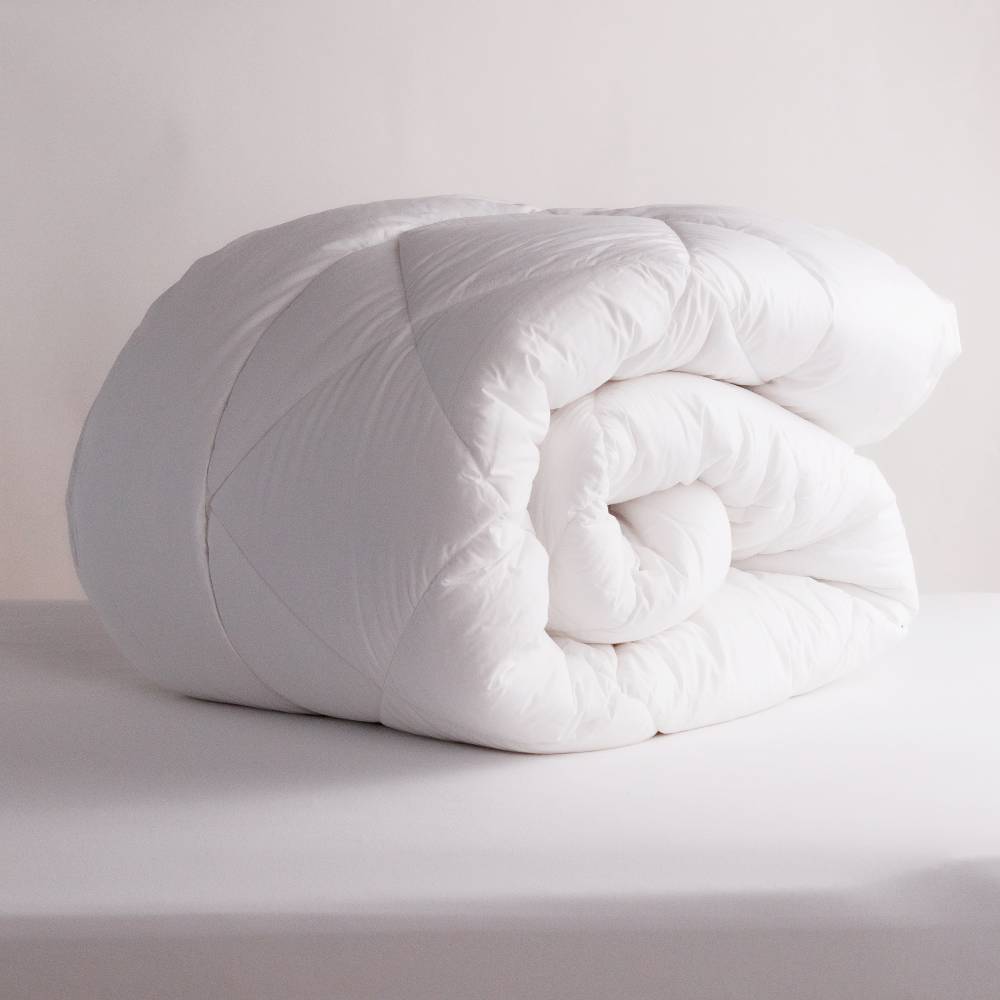 White Duvet Inner rolled up on a white background