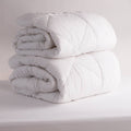 2 White Duvet Inners rolled up on a white background
