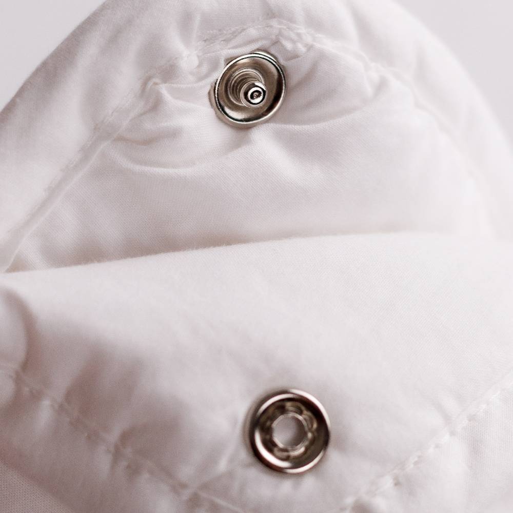 2 White Duvet Inners rolled up on a white background