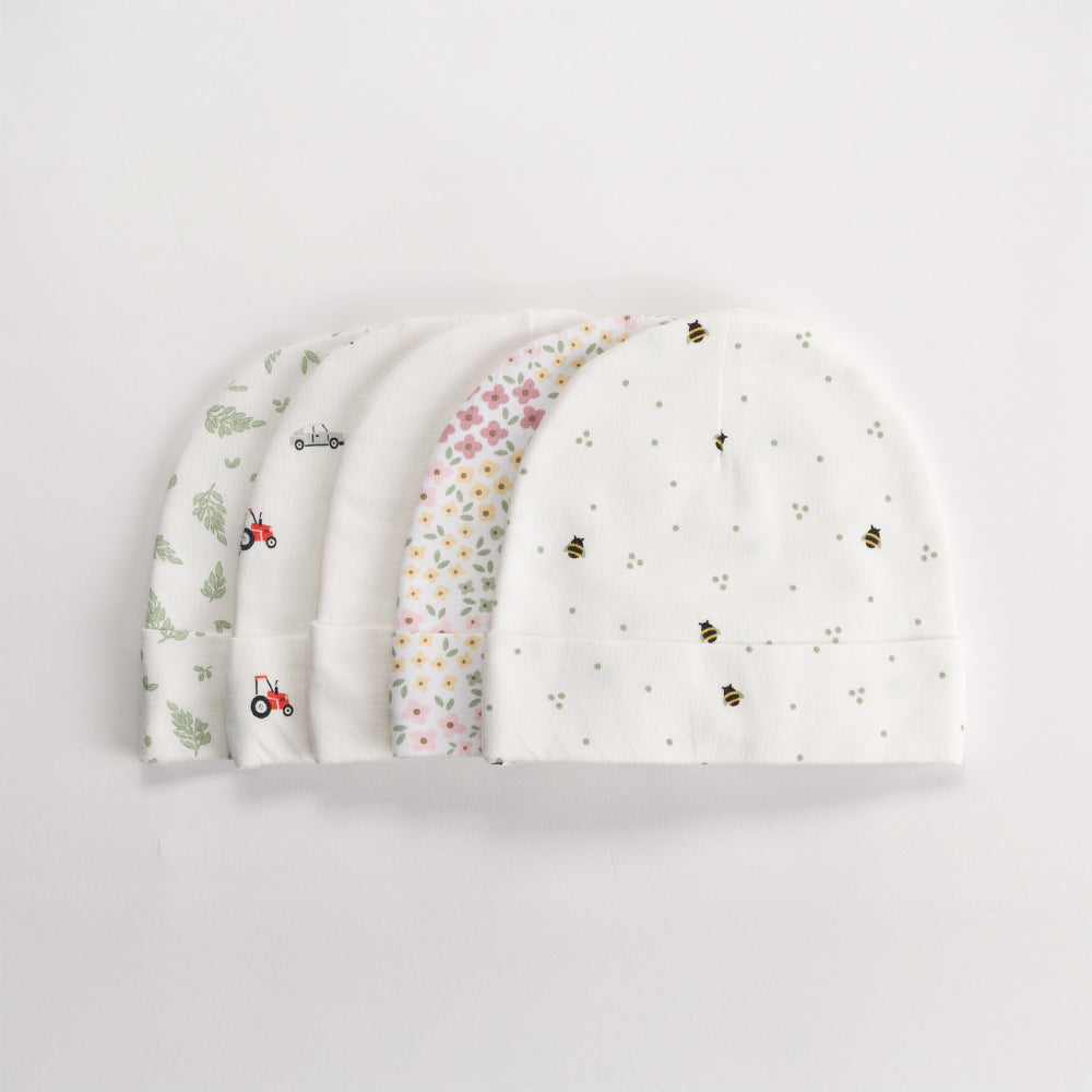 Set of four organic cotton baby hats with different patterns on a light gray background