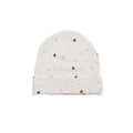 White organic cotton baby hat with small black and yellow bee pattern on a white background