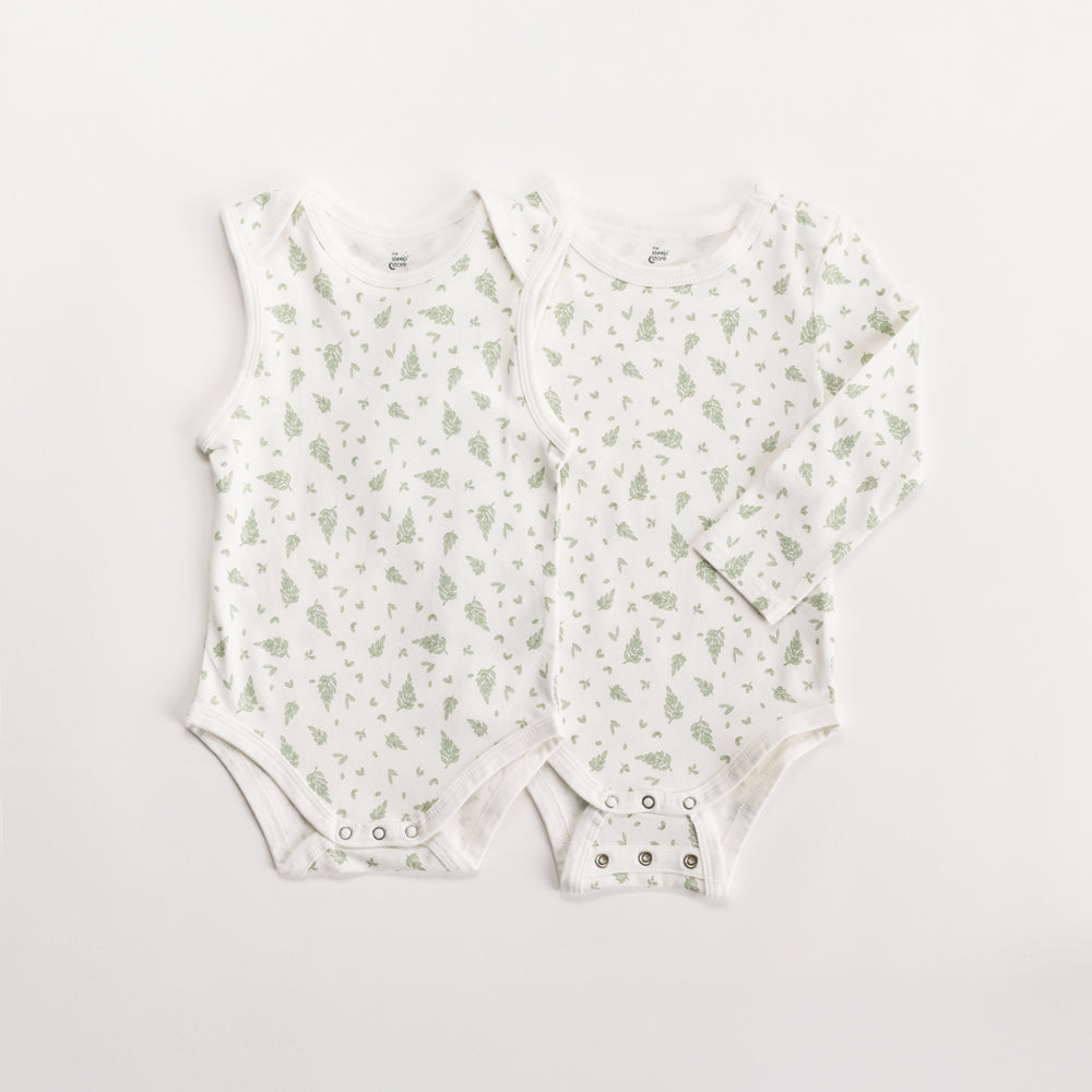 Two organic cotton baby bodysuits with a subtle green leaf pattern on a light gray background