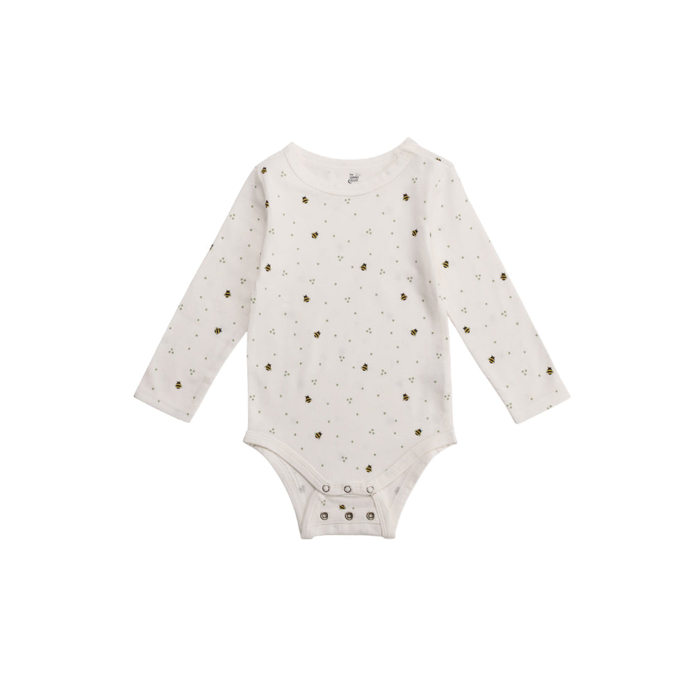 White cotton baby onesie with small bee patterns on a white background