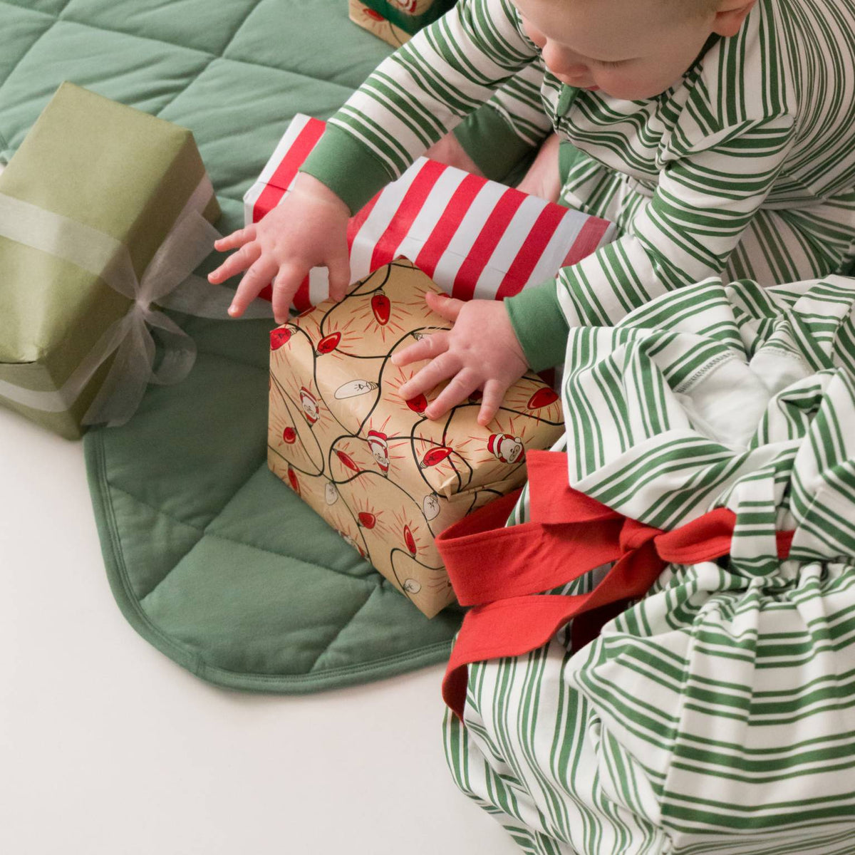 A baby opening presents. 