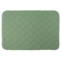 A fern green colour quilted blanket on a white background. 