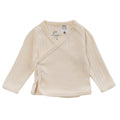 A cotton pointelle kimono cardigan in a beige babyccion colour, on a white background. A white fire label is present on this garment. 
