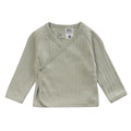 A cotton pointelle kimono cardigan in a sage green colour on a white background. A white fire label is present on the garment. 