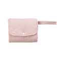 A folded Blush Pink quilted change mat on a white background. 