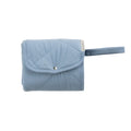 A folded Light  Blue quilted change mat on a white background. 