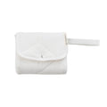 A folded Natural Cream quilted change mat on a white background. 