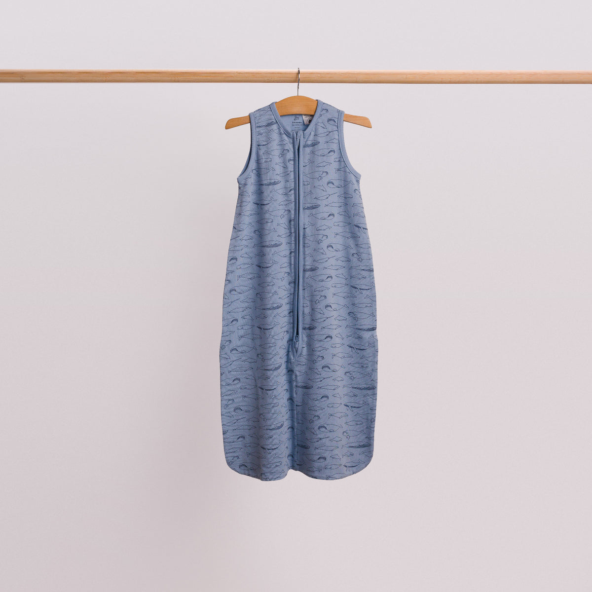 Hanging shot of a baby sleeping bag in the Blue Whales print. 