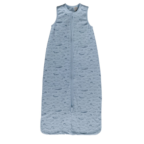 A sleeveless cotton baby sleep sack with blue whales on a blue background, shown flat against a white background.