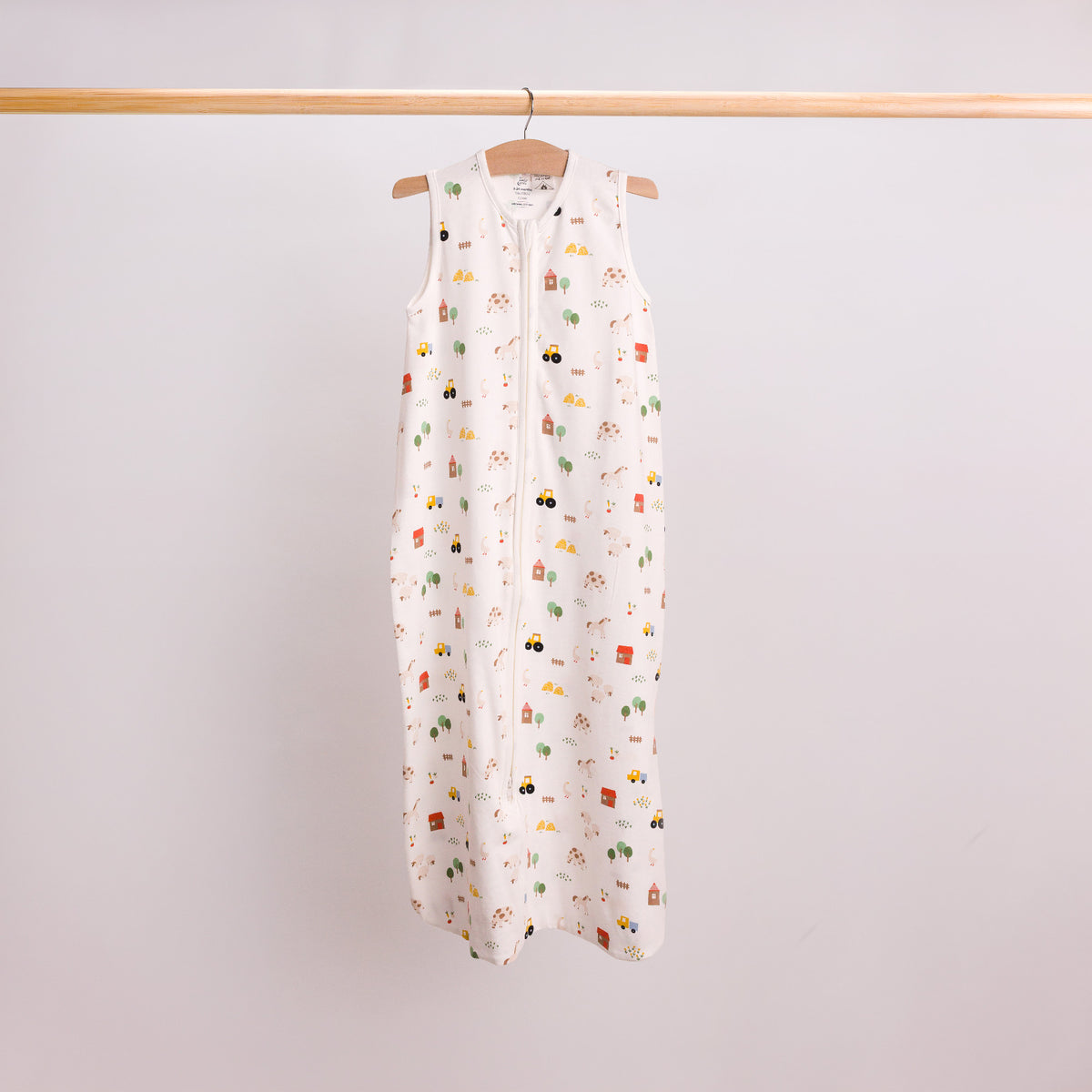 Hanging shot of a baby sleeping bag in the Farmyard print. 
