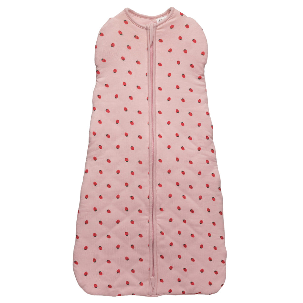 Pink baby sleeping bag with red polka dots on a white background