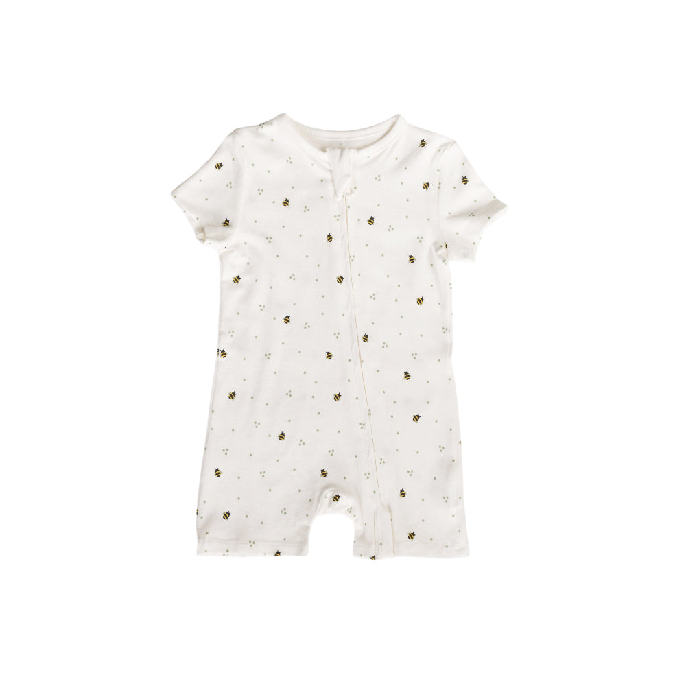 White cotton baby romper with small bees on a white background