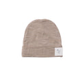 Beige baby beanie with a label on a white background