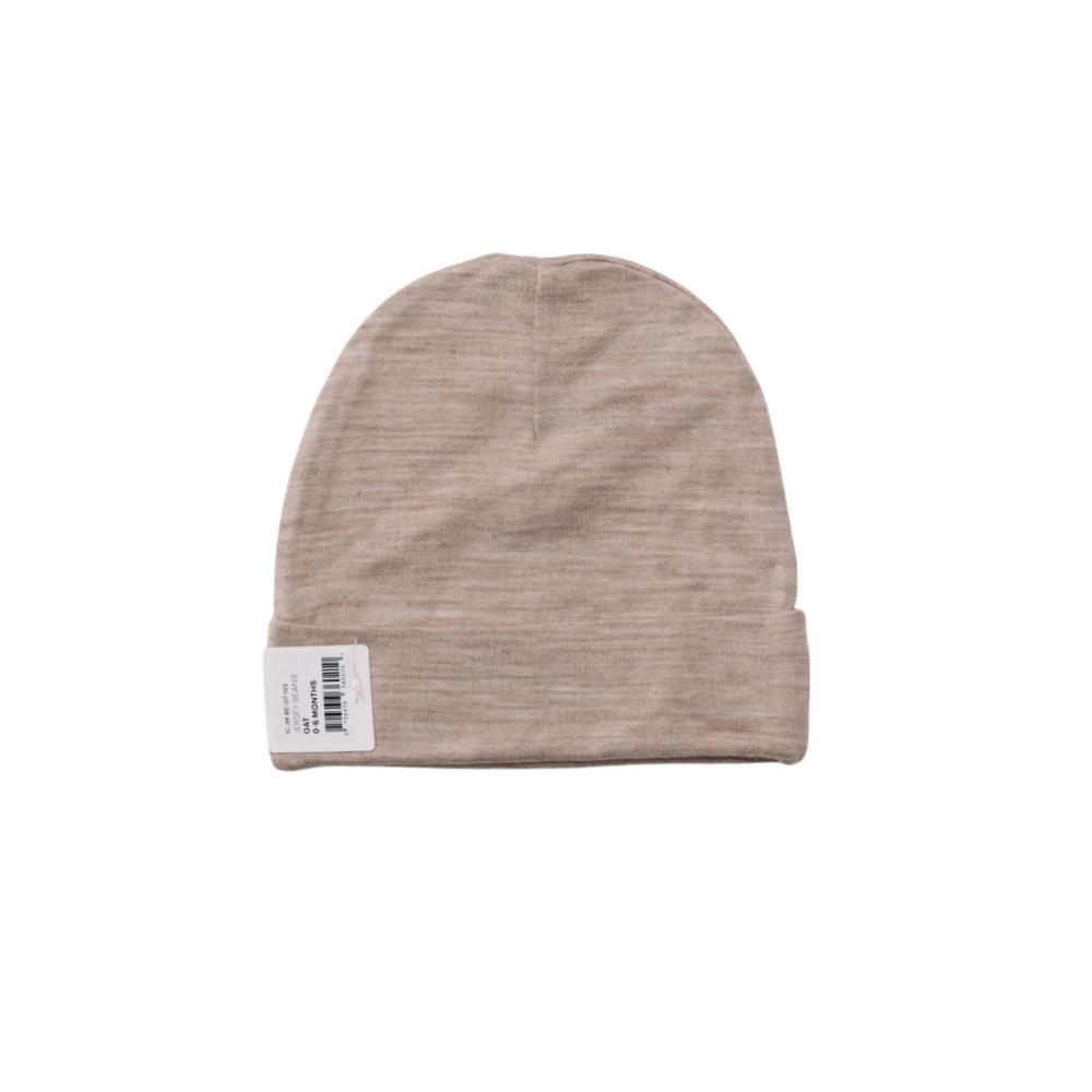 Beige baby beanie with a label on a white background