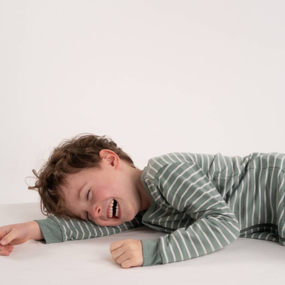 Child wearing a merino striped zipsuit