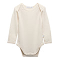 A long-sleeve deluxe merino rib cream-colored baby bodysuit with three snap buttons at the crotch, displayed flat against a solid white background.