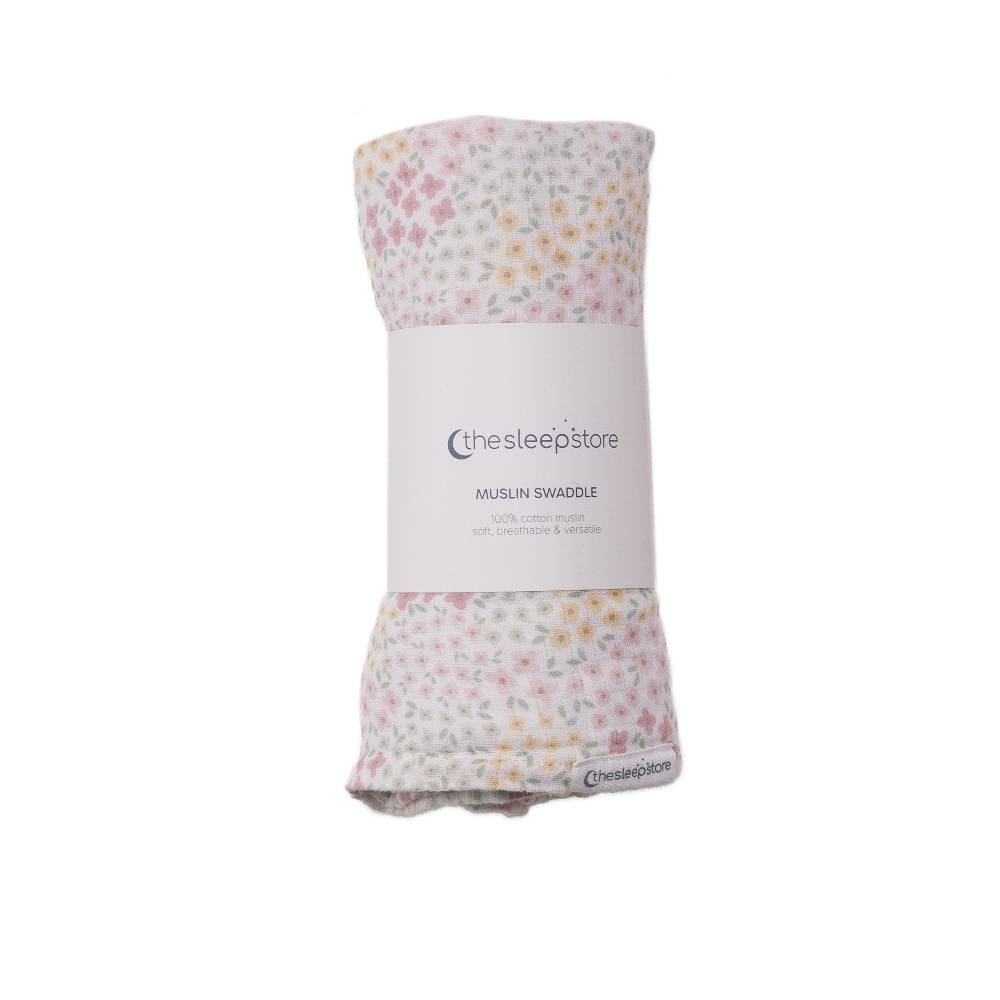 Floral patterned cotton muslin swaddle with packaging on a white background